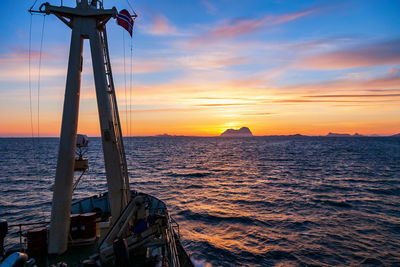 Sunset over a rocky archipelago from a ship on the sea