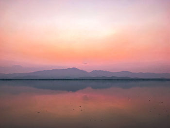 Scenic view of lake against romantic sky at sunset