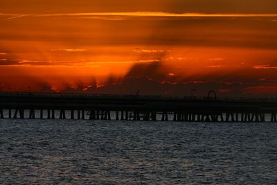 Scenic view of sea against orange sky