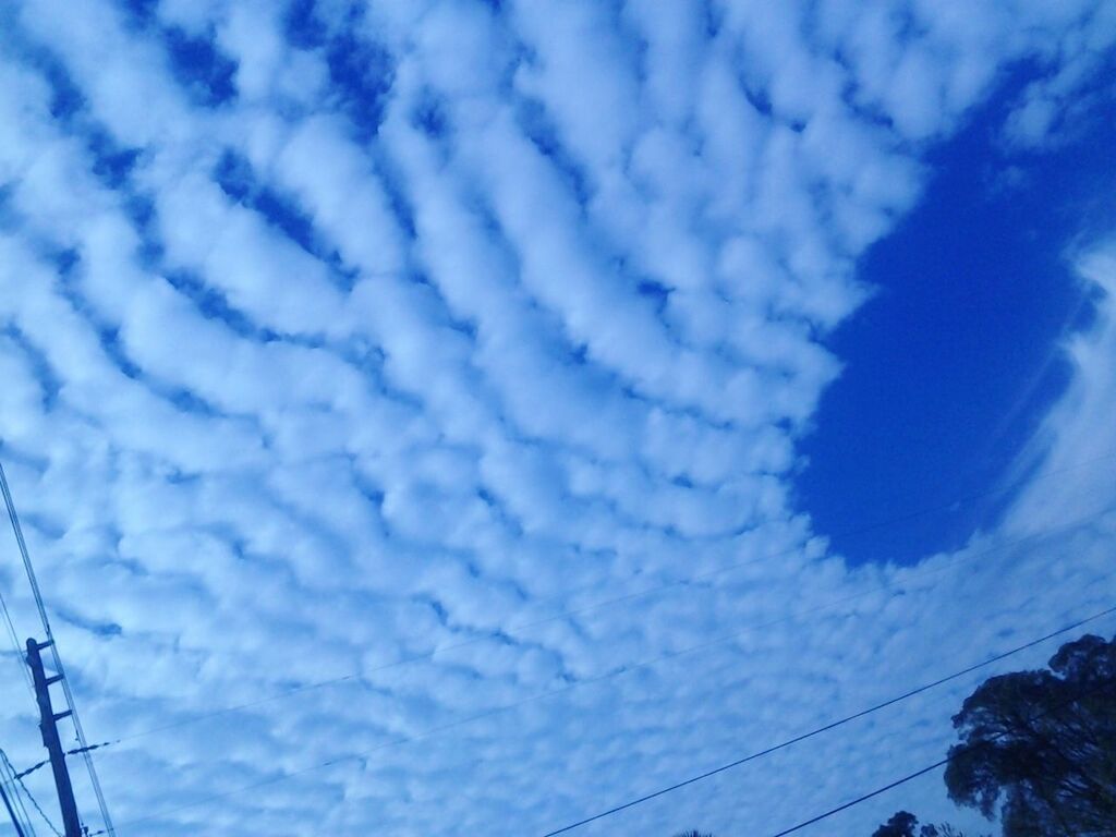 sky, cloud - sky, low angle view, blue, cloudy, beauty in nature, scenics, nature, cloud, tranquility, weather, power line, tranquil scene, cloudscape, no people, outdoors, day, connection, cable, transportation