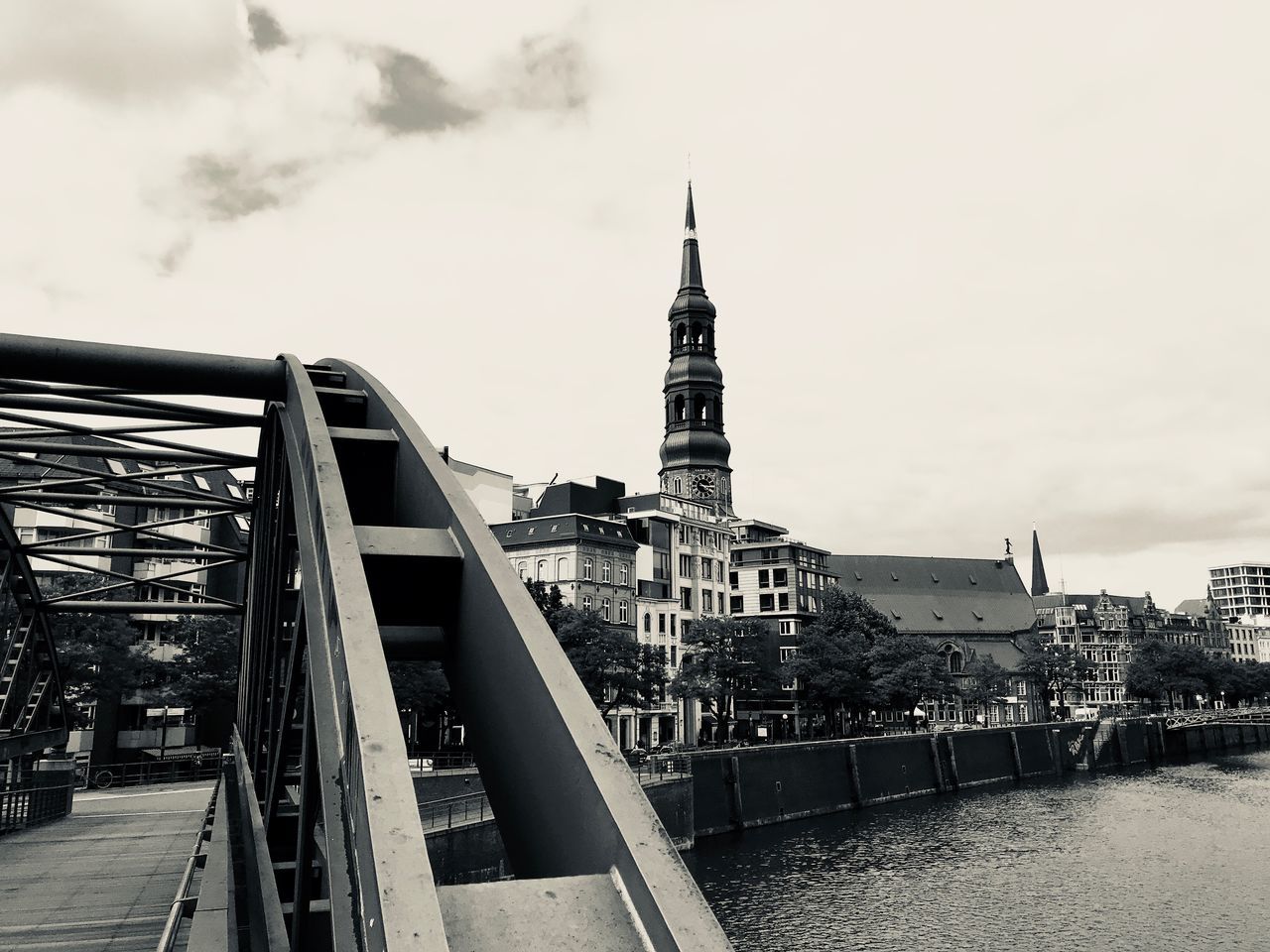 VIEW OF BUILDINGS BY RIVER AGAINST SKY