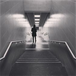 Rear view of woman walking in staircase