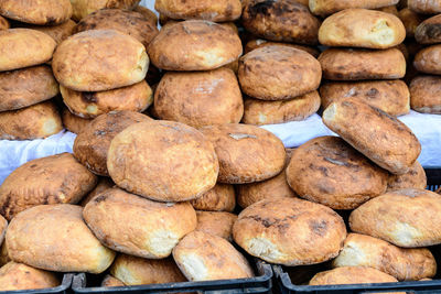 Heap of freshly baked whole-grain bread displayed for sale at a street food market, healthy food