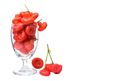 Close-up of red berries against white background