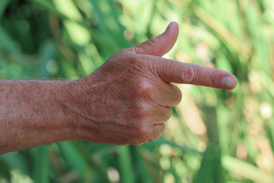 Close up of index finger pointing gesture on blurred background.