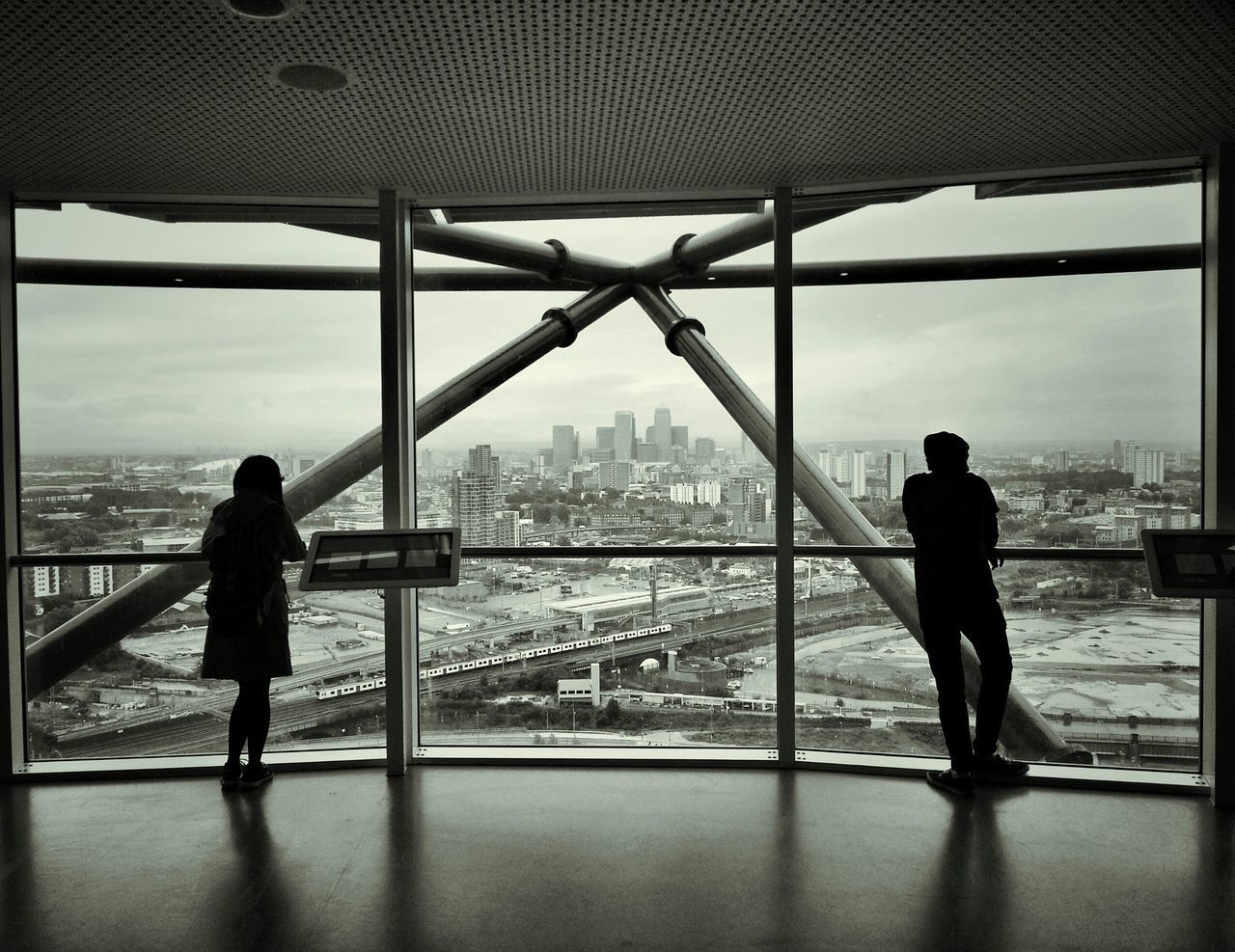 architecture, built structure, rear view, indoors, cityscape, men, building exterior, full length, city, lifestyles, standing, looking at view, sky, railing, silhouette, leisure activity, person, river