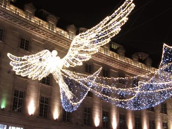 Low angle view of illuminated christmas tree at night