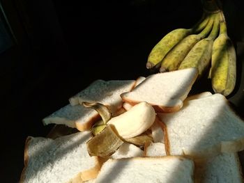 High angle view of banana on table against black background