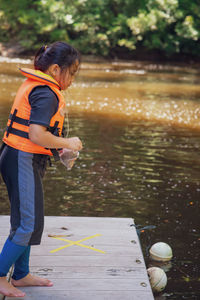 Side view of woman playing in lake