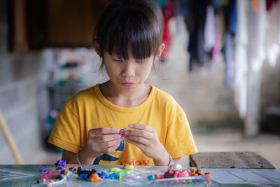 Cute girl playing with clay at home