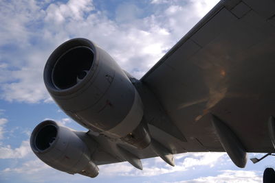 Low angle view of airplane flying against sky