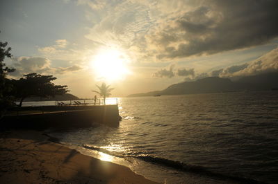 View of calm beach at sunset