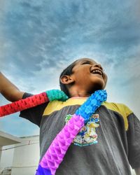 Low angle view of girl standing against multi colored sky