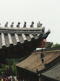 Low angle view of statues against clear sky