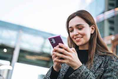 Young woman using mobile phone