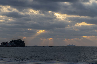 Scenic view of sea against dramatic sky