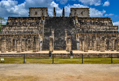 Low angle view of old temple against cloudy sky