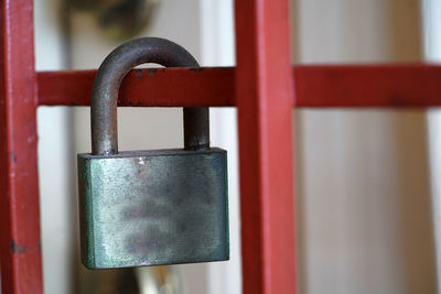 Close-up of padlocks on metal railing