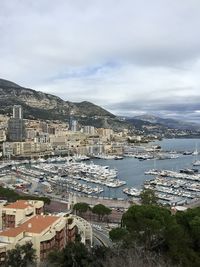 High angle view of city by sea against sky