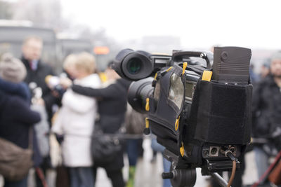 Close-up of camera against crowd