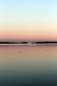 Scenic view of sea against clear sky at sunset