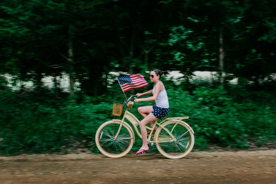 Child riding bicycle on a dirt road