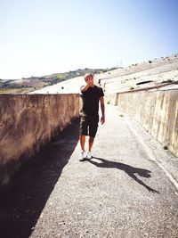 Full length of man on walkway against clear sky