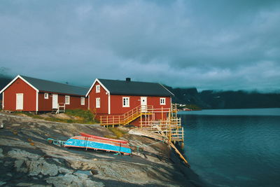 Houses by sea against sky