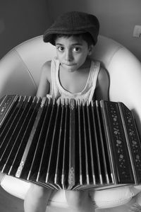 Top view of boy playing bandoneon