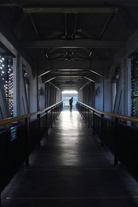 The shadow of a pedestrian in the alleys made of steel
