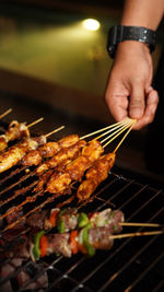 Cropped hand of man preparing food