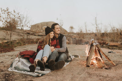 Young couple sitting on land