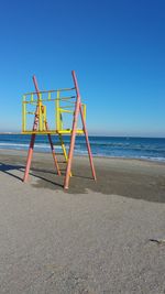 Lifeguard hut on beach against clear sky