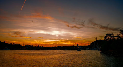 Scenic view of sea against romantic sky at sunset