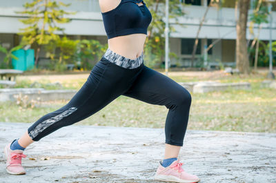 Low section of woman with arms raised