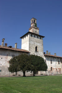 View of lawn against clear blue sky