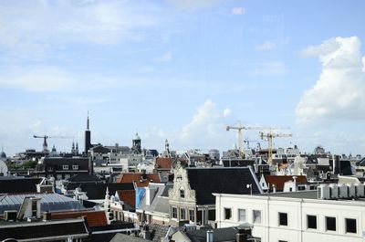 Cityscape against cloudy sky