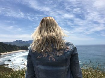 Rear view of woman against sea and sky