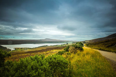 Scenic view of landscape against cloudy sky