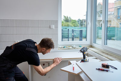 Side view of man working at home