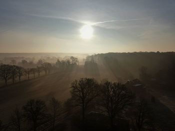 Scenic view of landscape against sky during foggy weather