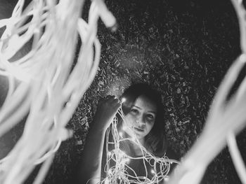 Portrait of young woman with horse in grass