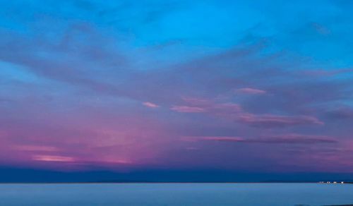 Scenic view of sea against sky at sunset