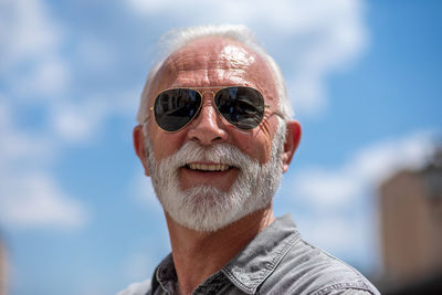 Portrait of man wearing hat against sky