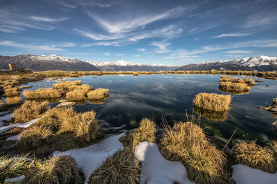 Scenic view of lake against sky during winter