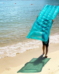 Rear view of woman standing on beach