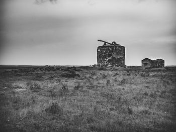 Old ruin on field against sky