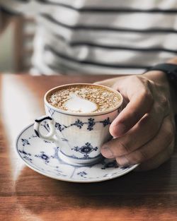 Close-up of woman holding coffee cup
