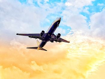 Low angle view of airplane flying against sky