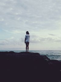 Rear view of man looking at sea